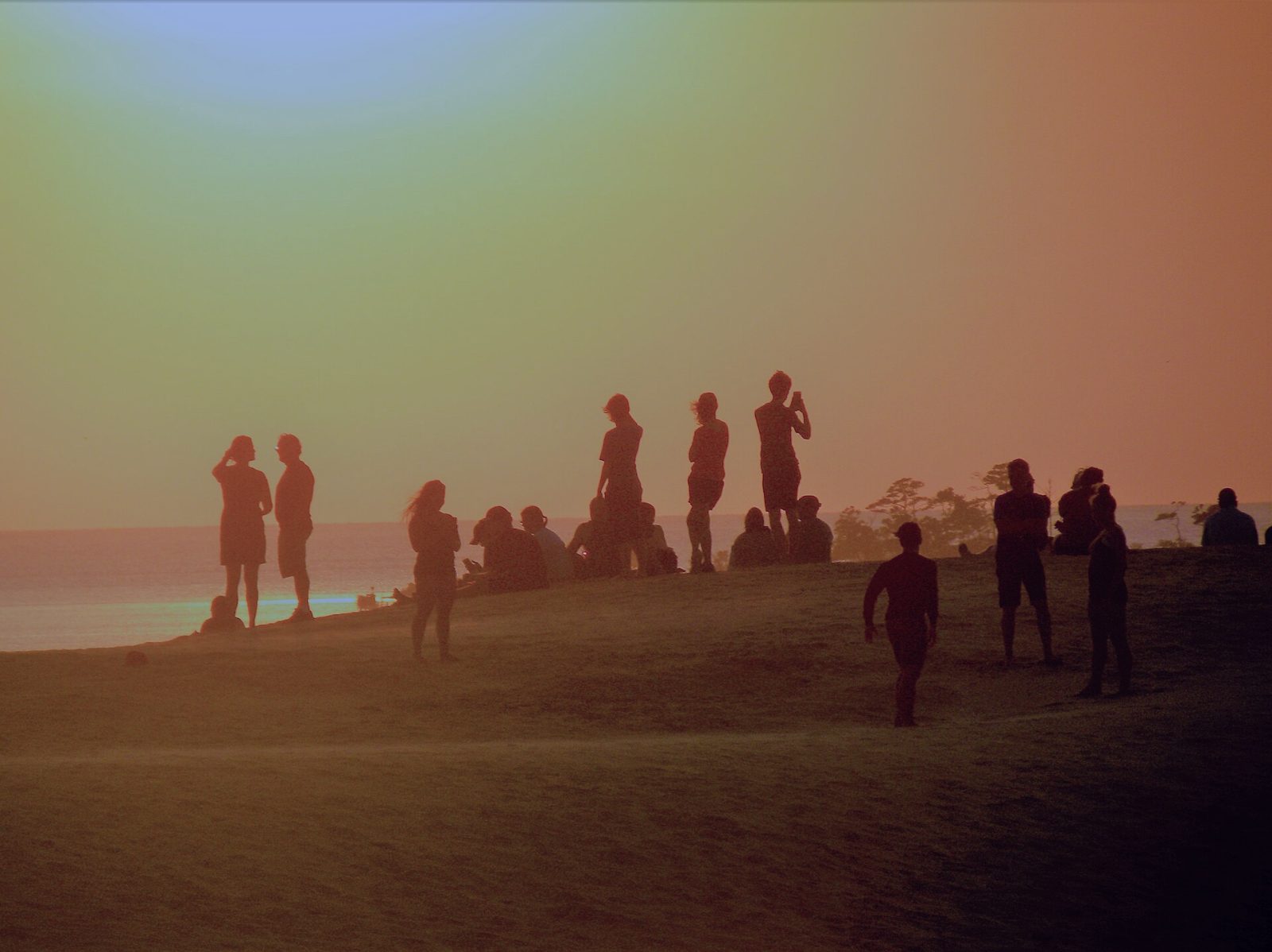 Beachgoers watching the sunset from the dunes at Kitty Hawk