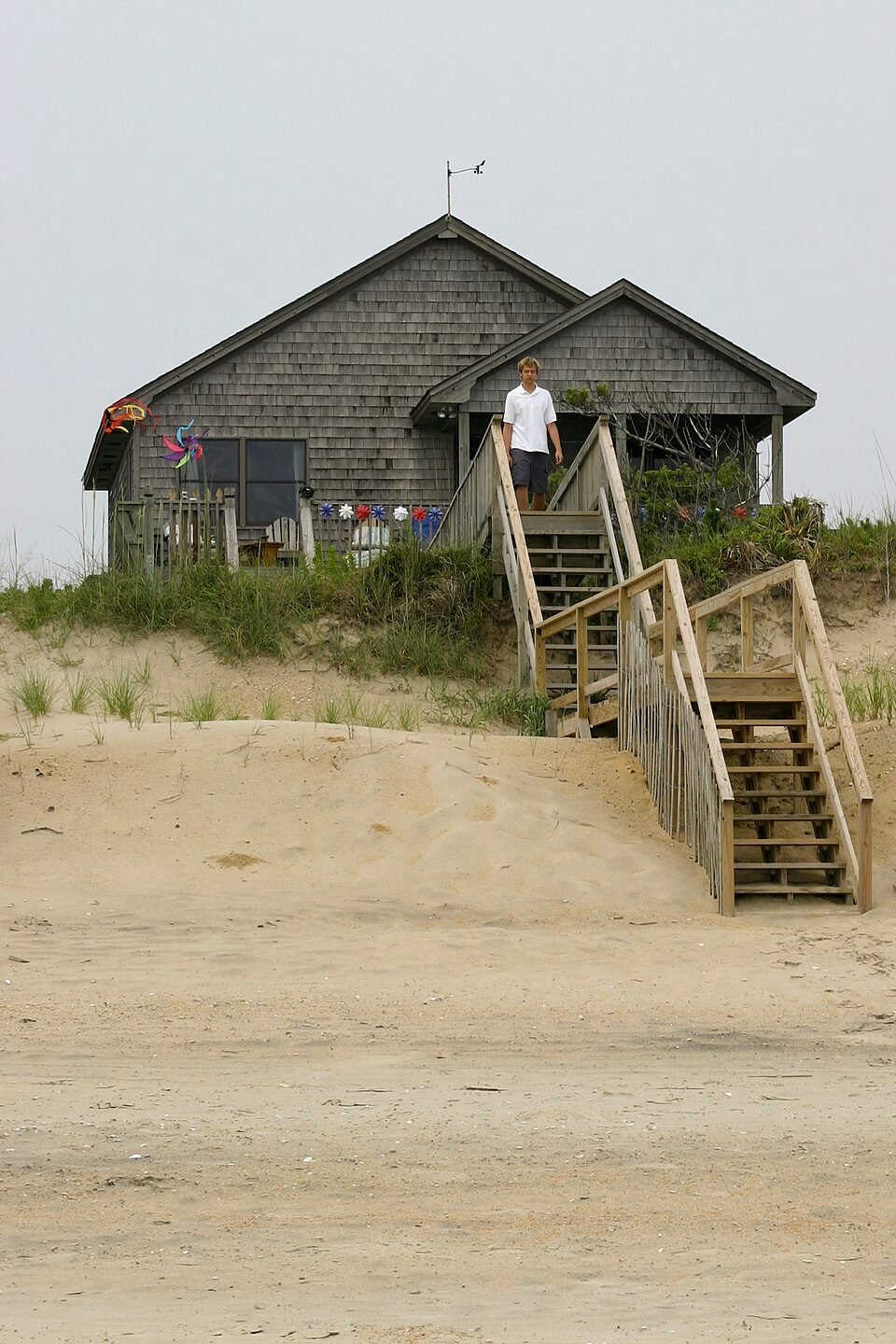 A weathered gray shingle cottage on the dunes on the Outer Banks