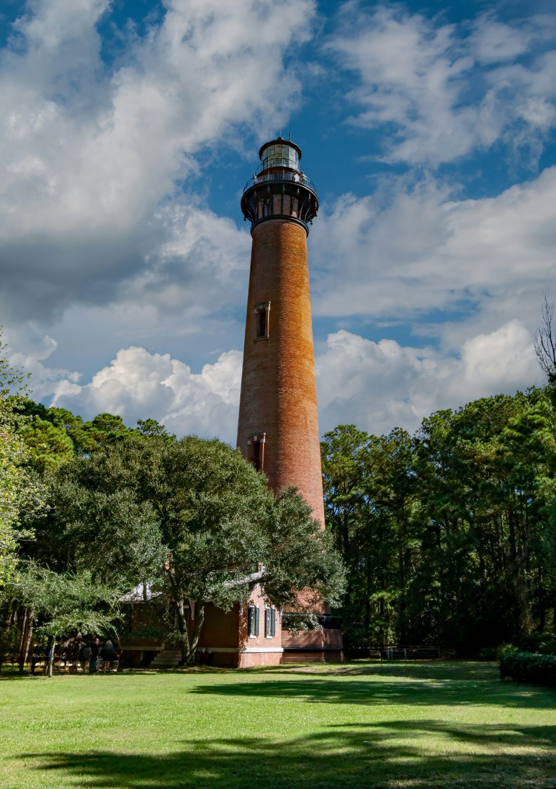 Currituck Beach Lighthouse rising above the trees in Corolla